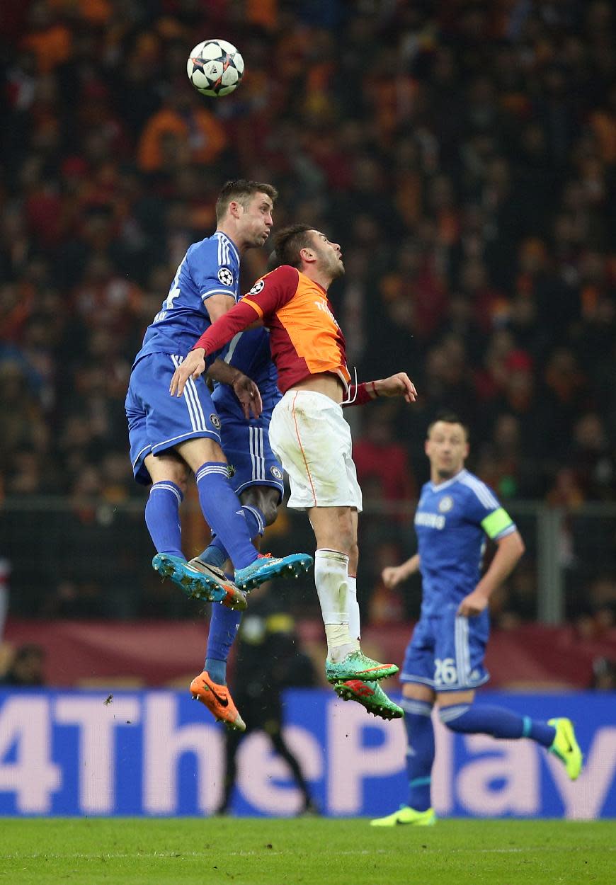 Burak Yilmaz of Galatasaray, right, and Gary Cahill of Chelsea fight for the ball during their Champions League Round of 16, First Leg soccer match between Galatasaray and Chelsea at Turk Telekom Arena Stadium in Istanbul, Turkey, Wednesday, Feb. 26, 2014. (AP Photo)