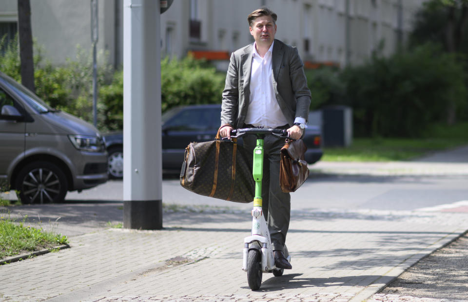 Far-right Alternative for Germany (AfD) top candidate for the European Parliament elections Maximilian Krah leaves a polling station on an e-scooter after casting his vote in the European and local elections in Dresden, Germany, Sunday, June 9, 2024. (Robert Michael/dpa via AP)