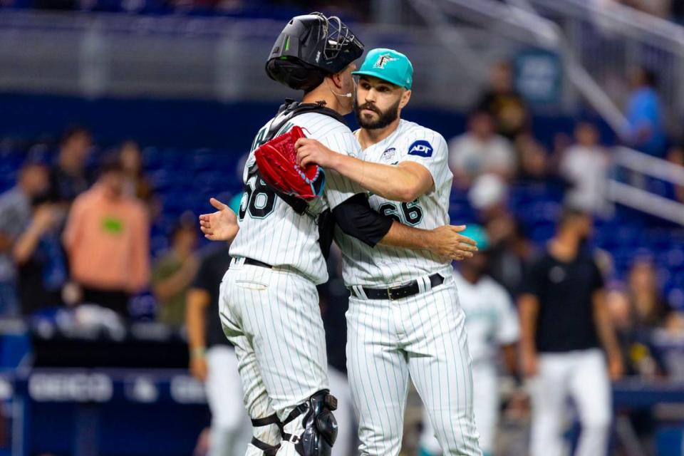 Miami Marlins pitcher Tanner Scott (66) reacts with catcher Jacob Stallings (58) after defeatig the Oakland Athletics 4-0 in nine innings of an MLB game at loanDepot park in the Little Havana neighborhood of Miami, Florida, on Friday, June 2, 2023.