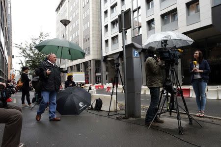 Journalists stand in front of the offices of the judicial police in Nanterre, near Paris, July 1, 2014, where former French President Nicolas Sarkozy arrived early Tuesday to be quizzed by investigators. REUTERS/Benoit Tessier