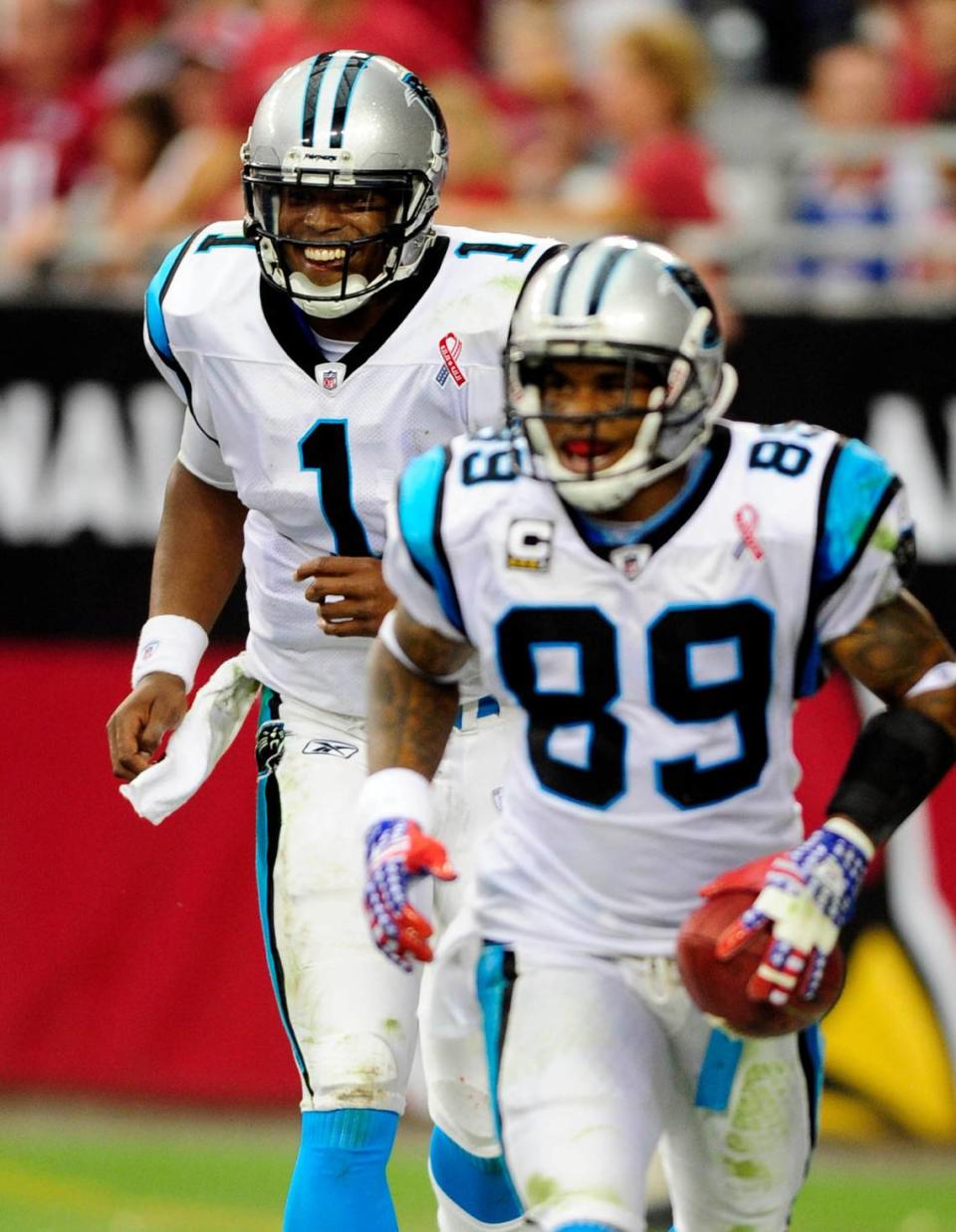 Carolina Panthers’ Cam Newton (1) smiles as he and Steve Smith (89) celebrate their second touchdown pass against the Arizona Cardinals on Sunday, September 11, 2011, at University of Phoenix Stadium. Arizona won, 28-21. Newton became the first rookie to throw for more than 400 yards in his NFL debut and threw TD passes to Smith of 75 and 26 yards. David T. Foster III-dtfoster@charlotteobserver.com