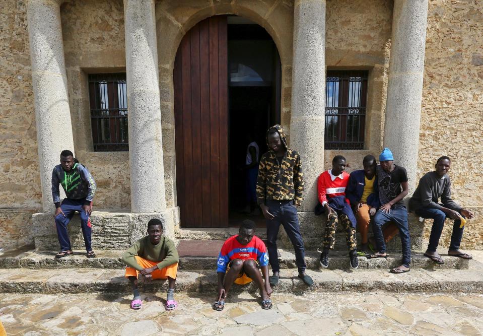 Adolescent migrants are seen at the courtyard of an immigration centre in Caltagirone, Sicily March 18, 2015. The number of migrants reaching Italy by sea this year is set to top last year's record of 170,000, the International Organization for Migration (IOM) said. In the past week alone 10,000 have arrived. Another 400 people drowned before making it to Italy's shores, survivors said. The number of minors traveling alone in this mass migration has soared -- underage arrivals to Italy tripled in 2014 from the previous year. Picture taken March 18, 2015. To match Insight ITALY-MIGRANTS/BOYS REUTERS/Alessandro Bianchi