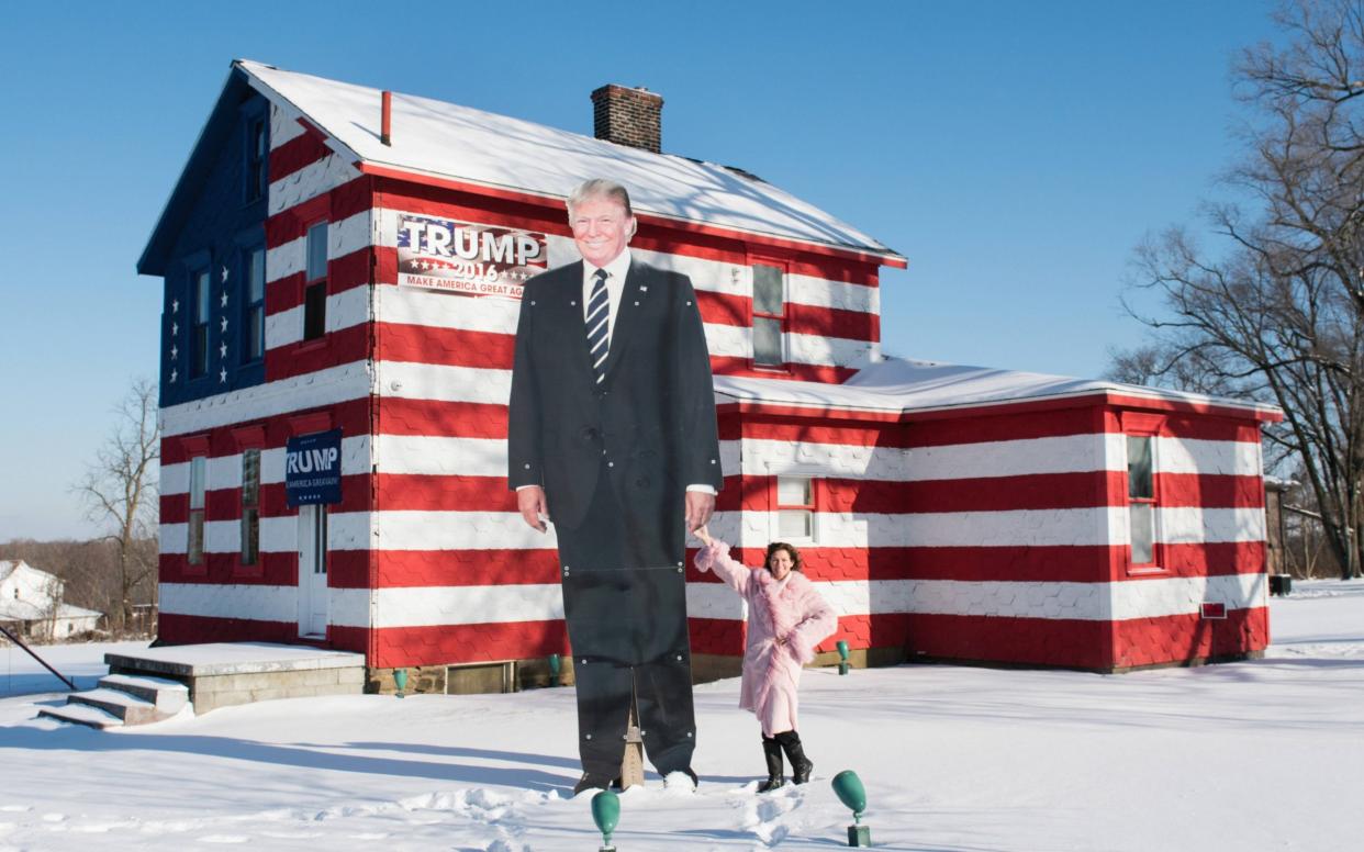 Ms Rossi holds the hand of the 14ft metal cutout of Donald Trump - Joe Appel for the Daily Telegraph