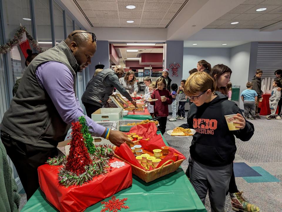 Newark Police Department volunteers served lunch to 85 Newark City Schools students, after they and their families shopped for Christmas gifts at Walmart during the Cops and Kids event.