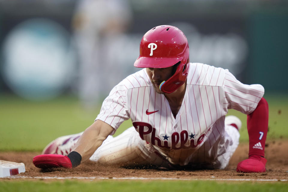 Philadelphia Phillies' Trea Turner slides back to first base on a pick-off attempt by Milwaukee Brewers pitcher Julio Teheran during the fifth inning of a baseball game, Tuesday, July 18, 2023, in Philadelphia. (AP Photo/Matt Slocum)