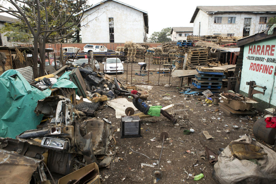 A man does excercises in a scrap yard, during lockdown due to the coronavirus, in Harare, Zimbabwe, Wednesday, April 8, 2020.The new coronavirus causes mild or moderate symptoms for most people, but for some, especially older adults and people with existing health problems, it can cause more severe illness or death.(AP Photo/Tsvangirayi Mukwazhi)