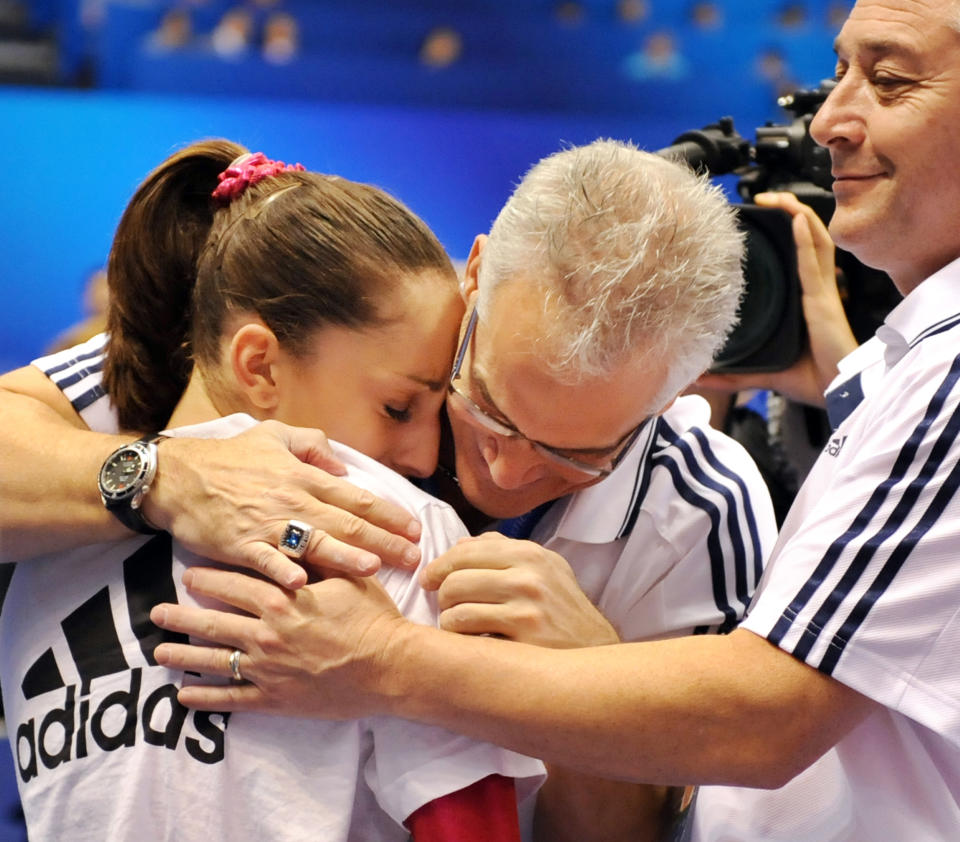 Jordyn Wieber of the US (L) celebrates her victory with her coaches in the women's all-around final at the World Gymnastics Championships in Tokyo on October 13, 2011. US national champion Jordyn Wieber won the women's all-around title at the championships.      AFP PHOTO/KAZUHIRO NOGI (Photo credit should read KAZUHIRO NOGI/AFP/Getty Images)