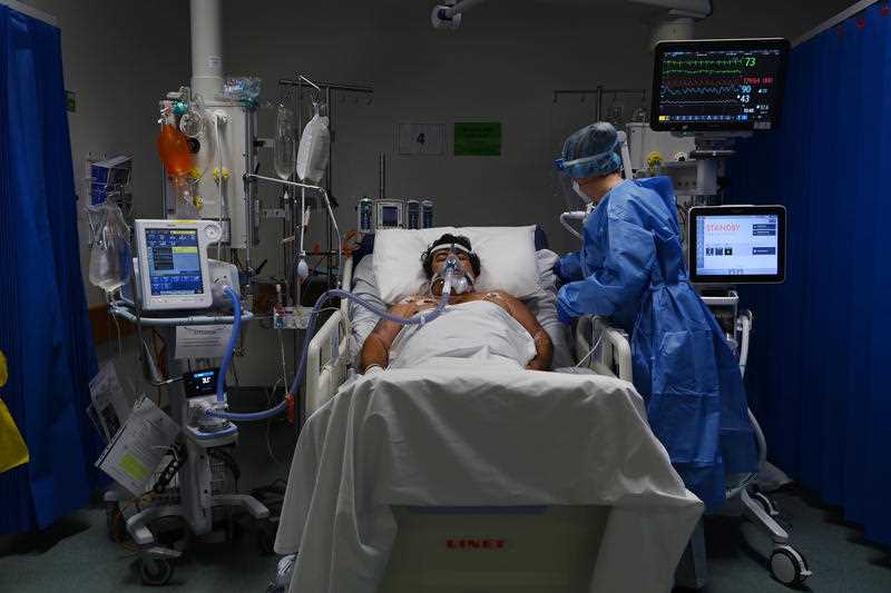 A supplied image of ICU Registered Nurse Shaunagh Whelan (right) caring for a COVID-19 positive patient in the ICU of St Vincent’s Hospital in Sydney.