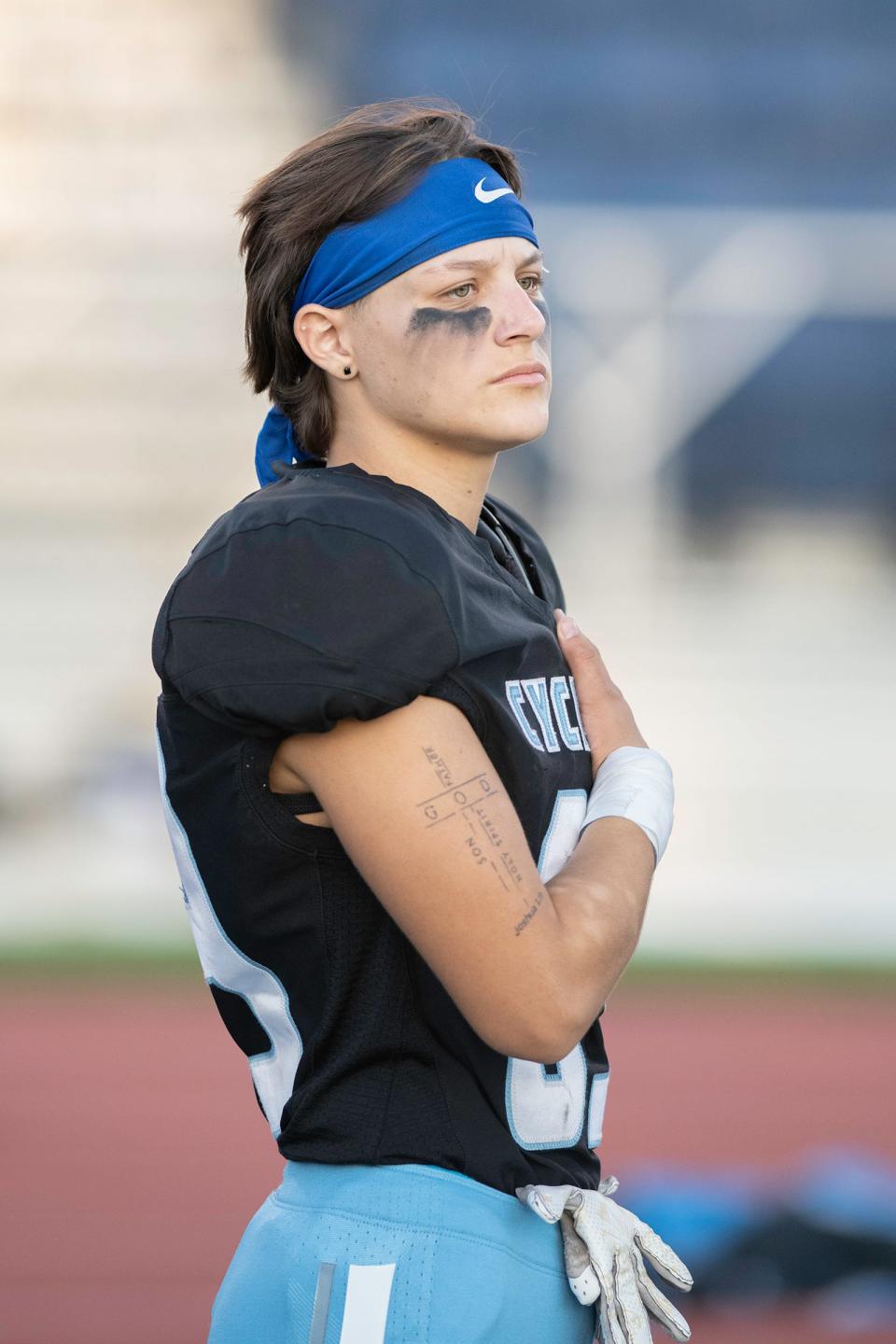 Pueblo West High School senior Alex Smith holds her hand on her heart during the National Anthem ahead of a game against Fountain-Fort Carson on Friday, September 8, 2023.
