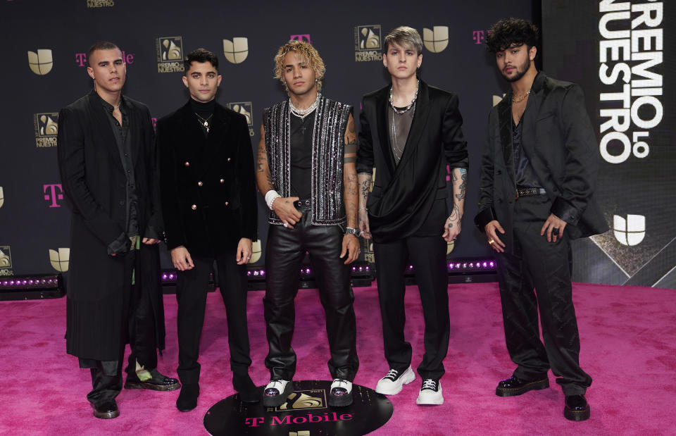 File- This Feb. 18, 2021, file photo shows Zabdiel De Jesus, from left, Erick Brian Colon, Richard Camacho, Christopher Velez and Joel Pimentel, of CNCO, arriving at Premio Lo Nuestro in Miami. The Latin American boy band CNCO is downsizing. The group announced on its official Instagram page Sunday, May 9, 2021, that 22-year-old Pimentel is leaving the band, making the successful quintet a quartet.(AP Photo/Lynne Sladky, File)