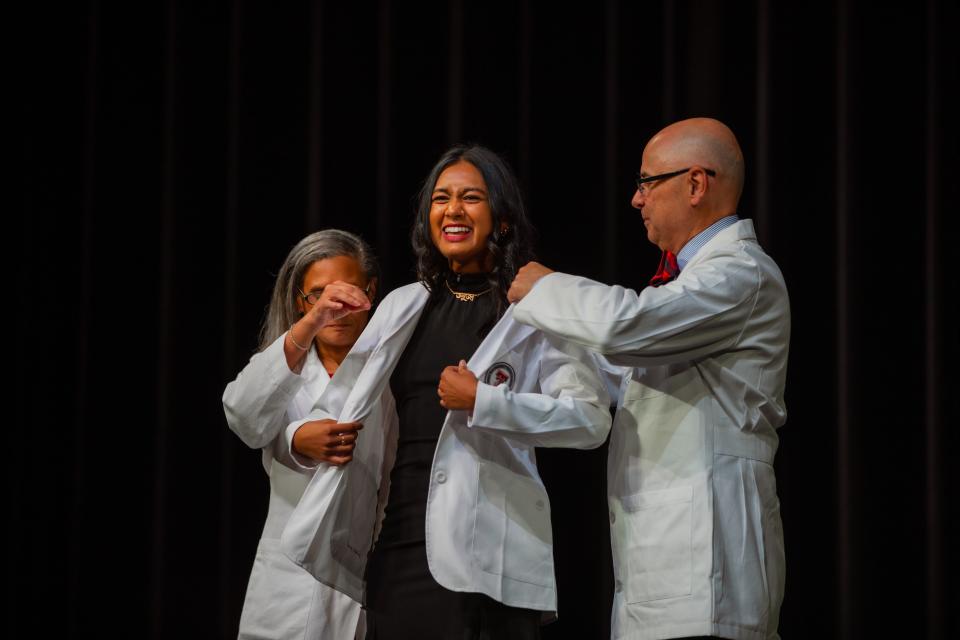 Tanuja Nath of Lubbock smiles as she receives her white coat during Friday's ceremony held by the Texas Tech University Health Sciences Center at the Buddy Holly Hall of Performing Arts and Sciences.