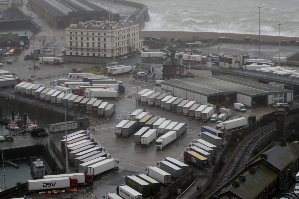 Lorries are parked near the port, Monday, Dec. 21, 2020, after the Port of Dover, England, was closed and access to the Eurotunnel terminal suspended following the French government's announcement. France banned all travel from the UK for 48 hours from midnight Sunday, including trucks carrying freight through the tunnel under the English Channel or from the port of Dover on England's south coast. (AP Photo/Kirsty Wigglesworth)