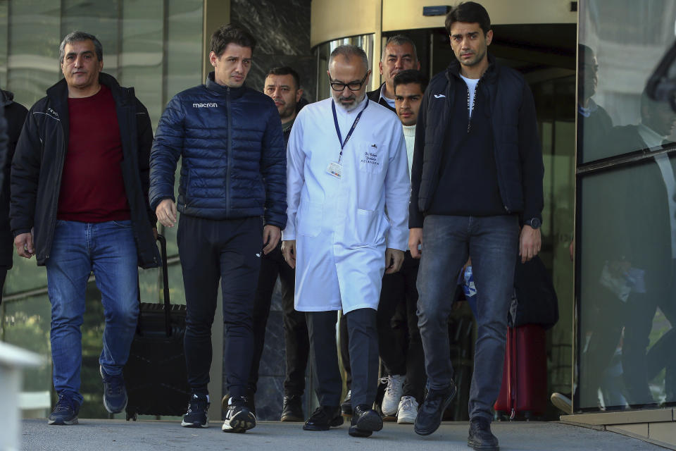 Turkish referee Halil Umut Meler, second left, leaves the Acibadem hospital in Ankara, Wednesday, Dec. 13, 2023. A top Turkish referee was discharged from a hospital on Wednesday where he was treated for a facial fracture after being punched by the president of a top-flight soccer club, leading to the Turkish Football Federation to suspend all league games. (AP Photo/Ali Unal)