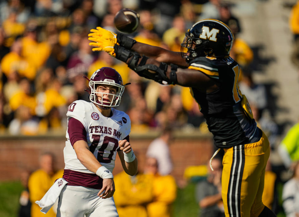 Oct 16, 2021; Columbia, Missouri, USA; Texas A&M Aggies quarterback Zach Calzada (10) throws a pass as Missouri Tigers defensive lineman Trajan Jeffcoat (18) during the first half at Faurot Field at Memorial Stadium. Mandatory Credit: Jay Biggerstaff-USA TODAY Sports