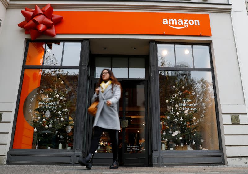 A customer leaves a new Amazon pop-up store for Christmas at Berlin's main shopping street Kurfurstendamm boulevard in Berlin