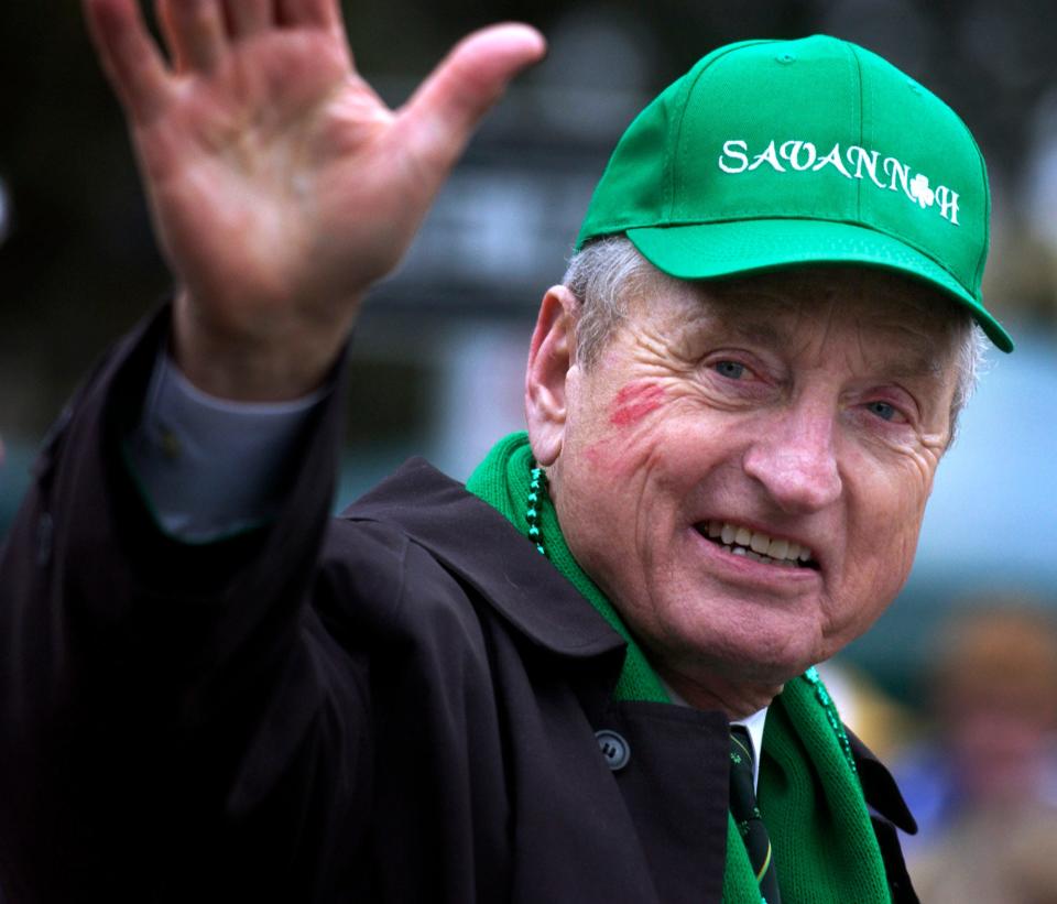 Former University of Georgia Football Coach and Athletic Director Vince Dooley waives to the crowd Thursday, March 17, 2005, after getting kissed on the cheek by a fan during the St. Patrick's Day parade in Savannah.