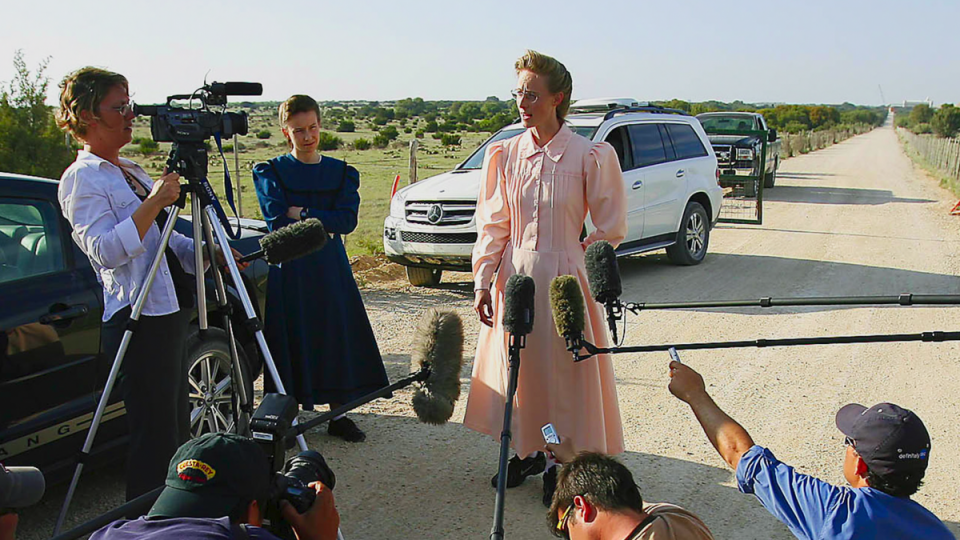 A woman from the FLDS speaks to the media after a 2008 police raid of an FLDS ranch (Courtesy of Netflix © 2022)