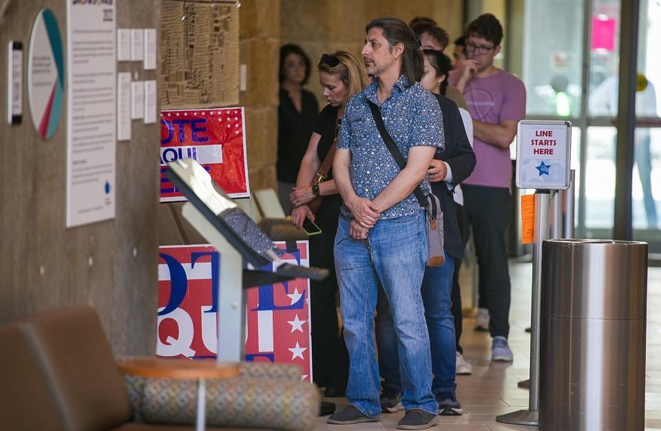 A line of voters waits at the Austin City Hall Center on Tuesday, March 5, 2024, in preparation for Super Tuesday. The line stretched just around the corner in a waiting area, with voters eager to cast their ballots. During this election, election officials ensured that the voting process was conducted smoothly.