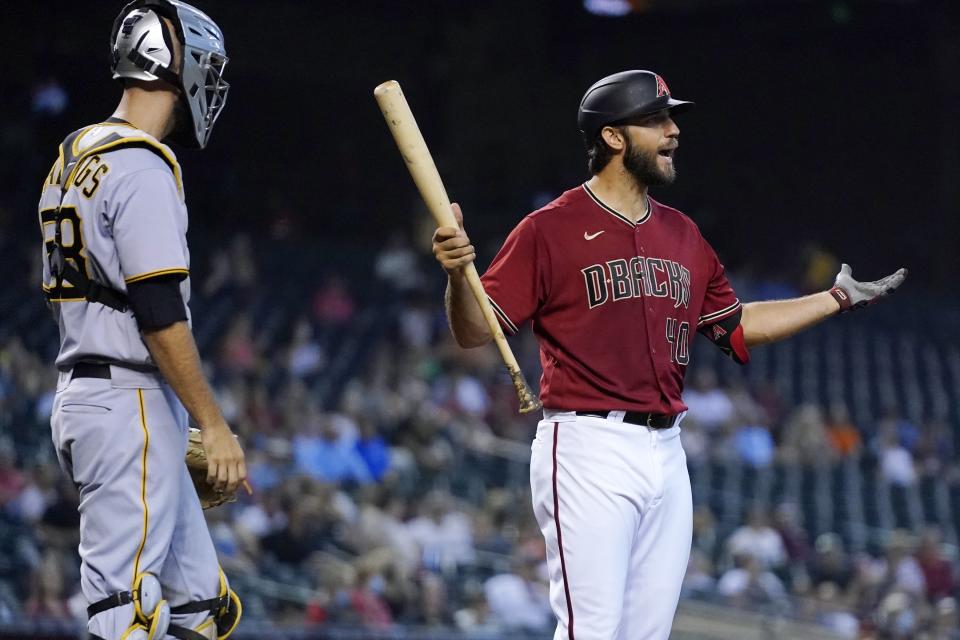 Arizona Diamondbacks' Madison Bumgarner argues a strike call on a bunt attempt as Pittsburgh Pirates catcher Jacob Stallings listens during the fourth inning of a baseball game Wednesday, July 21, 2021, in Phoenix. (AP Photo/Ross D. Franklin)