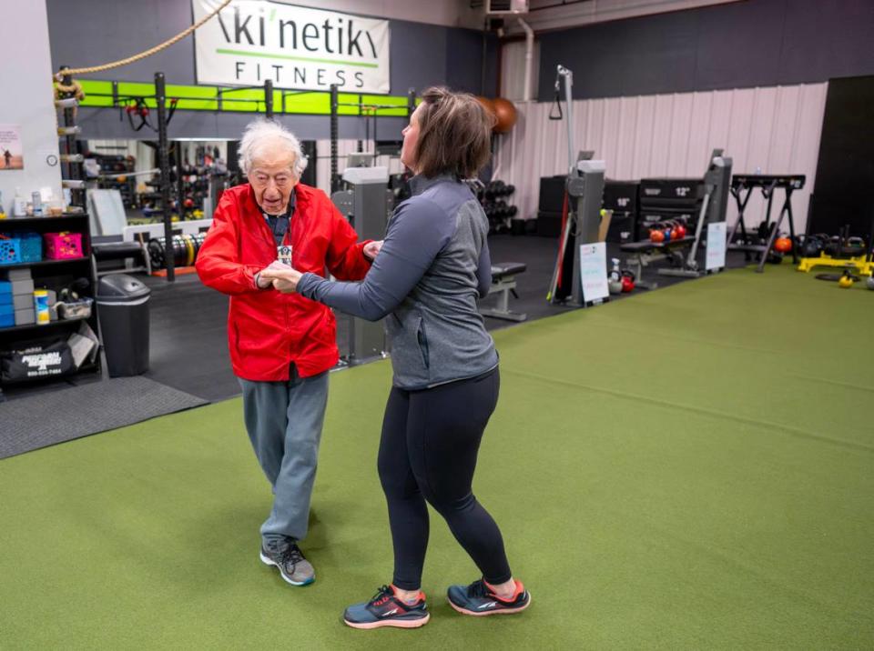 George Etzweiler “dances” with Berta DeDonato as he warms up for his work out at Ki’netik Fitness on Friday, April 5, 2024.