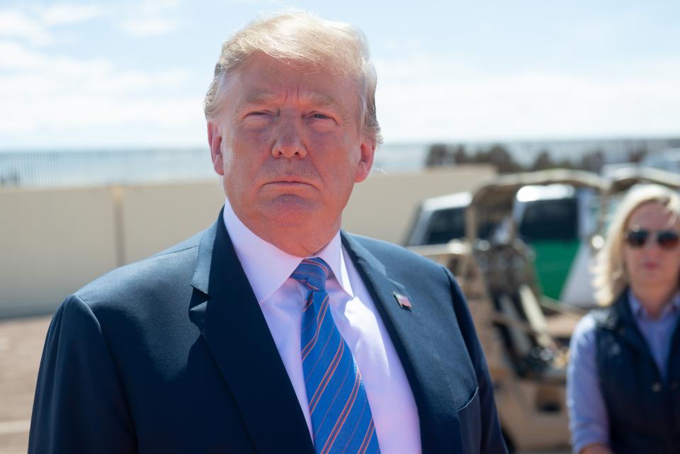 US President Donald Trump speaks with members of the US Customs and Border Patrol as he tours the border wall between the United States and Mexico in Calexico, California on April 5, 2019. - President Donald Trump landed in California to view newly built fencing on the Mexican border, even as he retreated from a threat to shut the frontier over what he says is an out-of-control influx of migrants and drugs. (Photo by SAUL LOEB / AFP)        (Photo credit should read SAUL LOEB/AFP/Getty Images)