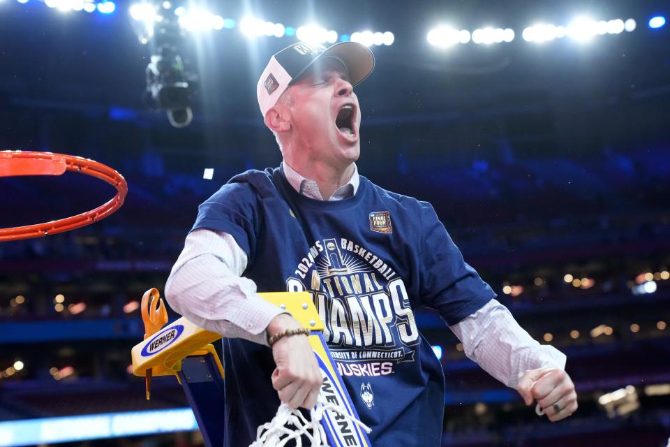 Connecticut Huskies head coach Dan Hurley cuts down the cut after defeating the Purdue Boilermakers in the national championship game of the 2024 NCAA Tournament in Glendale, Ariz.