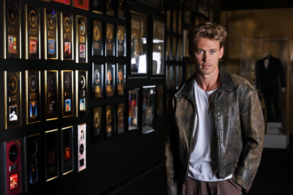Austin Butler, who plays Elvis Presley in the new "Elvis" biopic, poses for a portrait with the rock pioneer's gold records at Graceland in Memphis.