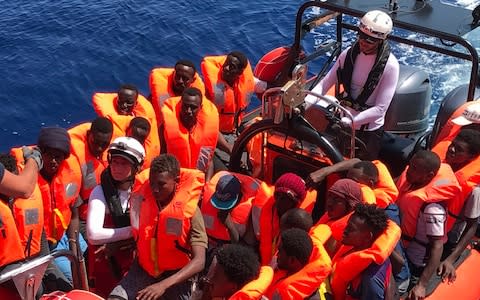 A "rhib", an inflatable dinghy, belonging to the 'Ocean Viking' rescue ship, operated by French NGOs SOS Mediterranee and Medecins sans Frontieres (MSF), transports rescued migrants  - Credit: Anne Chaon/AFP