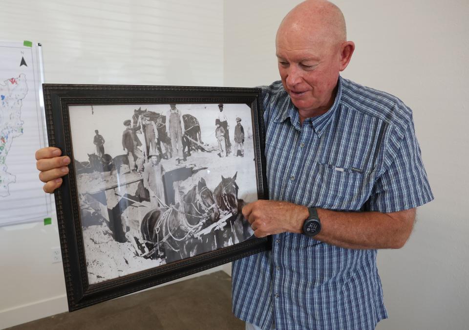 Mike Styler holds a 1915 photo of his grandfather working on the Yuba Reservoir as the Millard County Farm Bureau hosts a tour of alfalfa farms, water improvements and a dairy to showcase local agriculture in Delta on Wednesday, Sept. 6, 2023. | Jeffrey D. Allred, Deseret News