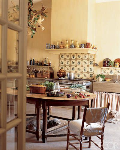 <p>Antique patterned tiles from Southern Italy make for a lively backsplash in a <a href="https://www.elledecor.com/design-decorate/room-ideas/g624/one-of-a-kind-kitchen-lighting/?slide=42" rel="nofollow noopener" target="_blank" data-ylk="slk:17th-century farmhouse;elm:context_link;itc:0;sec:content-canvas" class="link ">17th-century farmhouse</a> in the South of France. A Louis XIV farm table, a skirted farm sink, and ample open shelving complete the design. <br></p>