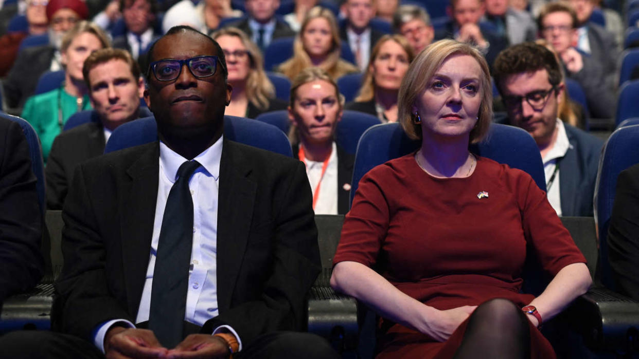 Britain's Chancellor of the Exchequer Kwasi Kwarteng (L) and Britain's Prime Minister Liz Truss (R) attend the opening day of the annual Conservative Party Conference in Birmingham, central England, on October 2, 2022. - UK's new Prime Minister will have plenty of critics lying in wait at what the Tories bill as Europe's largest annual political event. (Photo by Oli SCARFF / AFP)