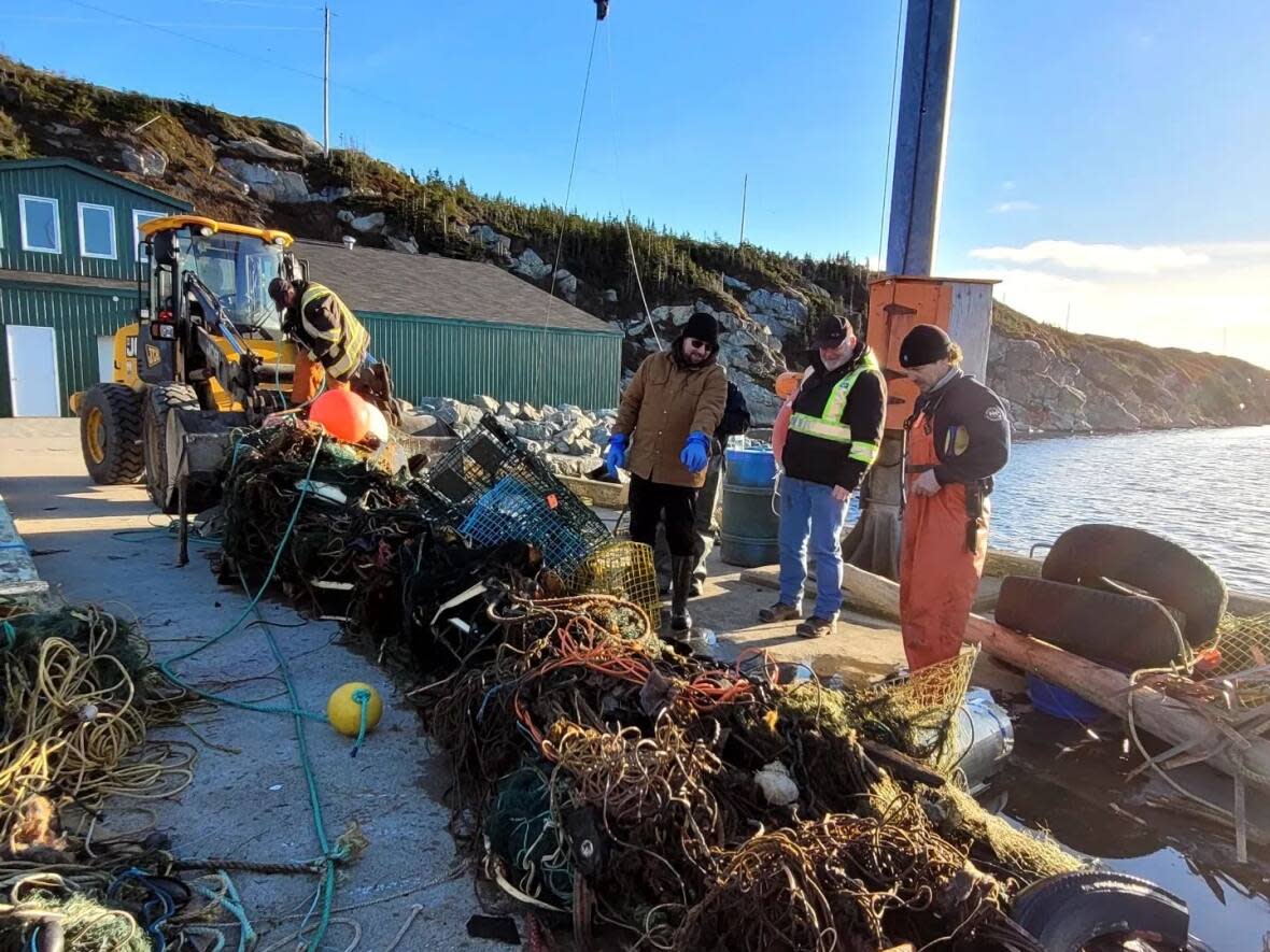 Crew members from the Atlantic Healthy Oceans Initiative team stand over one of the larger pulls from the ocean.  (Atlantic Healthy Oceans Initiative/Facebook - image credit)