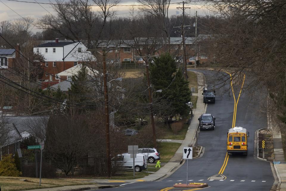 An electric school bus travels through Chevy Chase, Md., Friday, Feb, 2, 2024. (AP Photo/Tom Brenner)