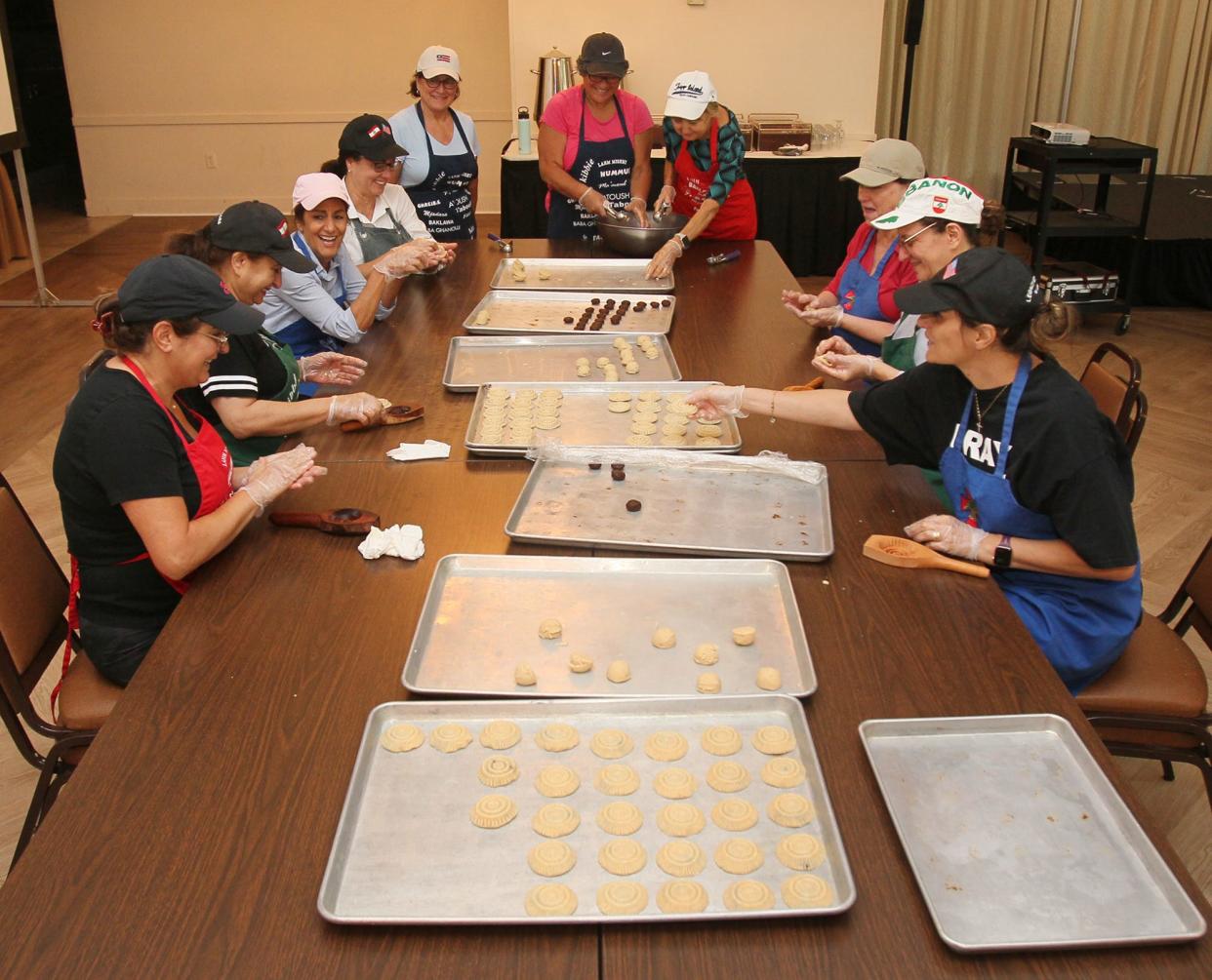 Members of Our Lady of the Cedars prepare ma'mool cookies at the church July 18. They are preparing for the church's annual Lebanese Festival Aug. 5-6.