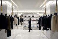 A customer walks in A department store in Paris, Thursday, Dec.19, 2019. French retailers, hotels and cafes are struggling at the height of the holiday shopping season, because a protracted transportation strike and repeated protests in Paris and other cities are keeping shoppers and visitors away. And it's the second year in a row _ last year's Christmas season was hit by yellow vest protests. (AP Photo/Thibault Camus)