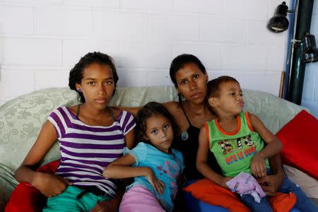 Alejandra Jordan (2nd R), 30, poses for a picture with her children (L-R) Valentina, 13, Valeria, 6, and Josue, 4, ahead of her sterilization surgery, at their home in San Francisco de Yare, Venezuela July 11, 2016. REUTERS/Carlos Garcia Rawlins