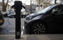 Electric cars are plugged into a charging point in London, Britain, April 7, 2016. REUTERS/Neil Hall/File Photo