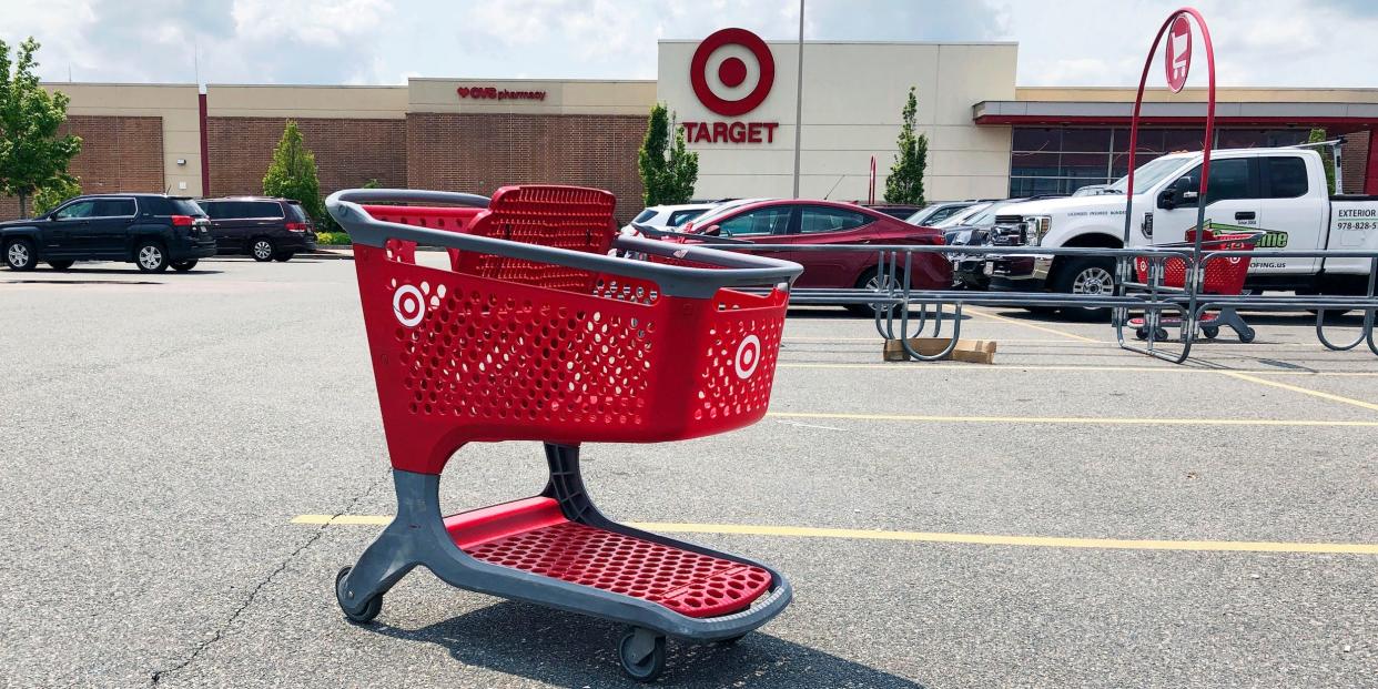 Empty Target shopping cart in parking lot in front of Target store