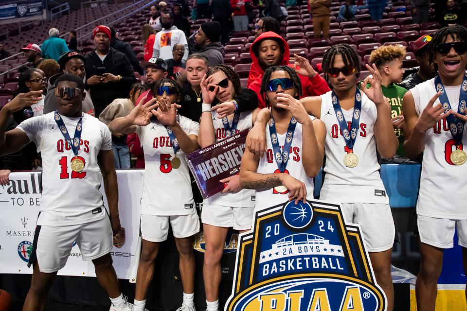 Aliquippa players pose for photos with their supporters in the stands after winning the PIAA Class 2A Boys Basketball Championship against Holy Cross at the Giant Center on March 22, 2024, in Hershey. The Quips won, 74-52, to claim their sixth state title in program history.