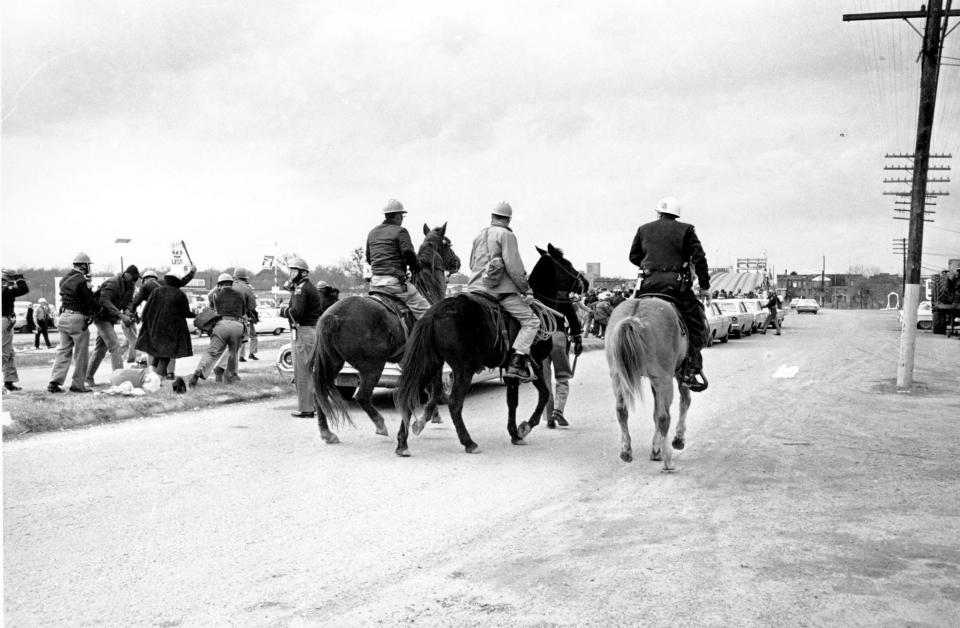 Alabama police troopers on horseback watch as troopers on the ground swing their clubs at demonstrators in Selma, Ala., on what is known as Bloody Sunday on March 7, 1965. Supporters of Black voting rights organized a march from Selma to Montgomery to protest the killing of a demonstrator by a state trooper and to improve voter registration for Black Americans, who were discouraged from registering.