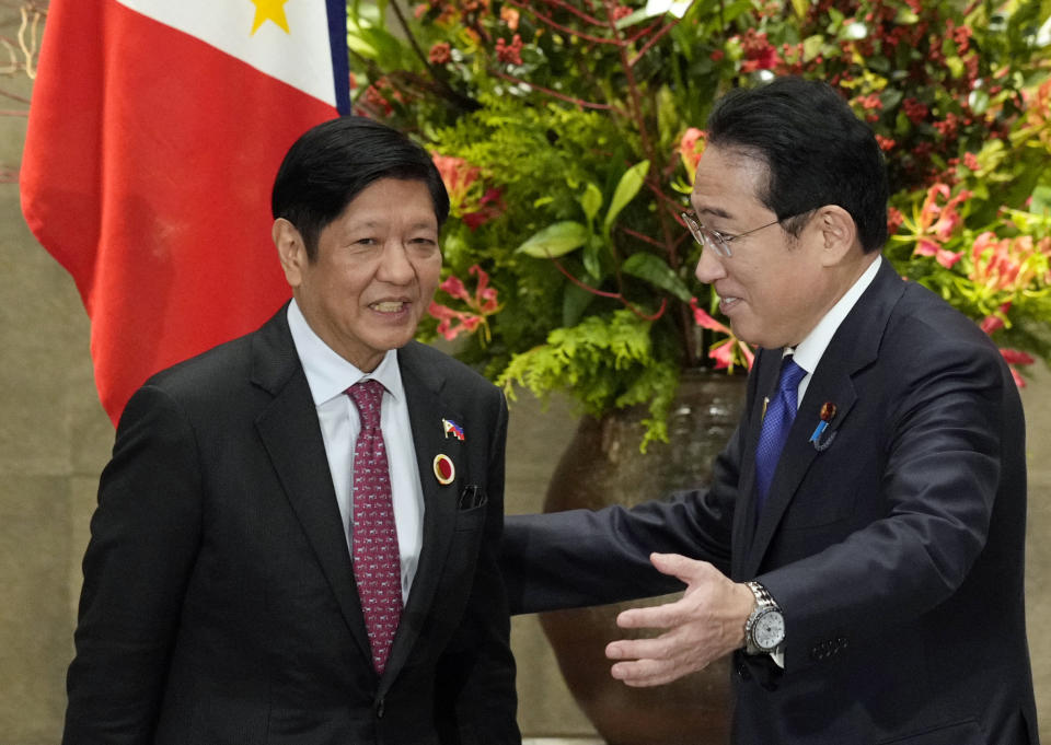 FILE - Japan's Prime Minister Fumio Kishida, right, greets Philippines' President Ferdinand Marcos Jr. prior to their bilateral meeting at the prime minister's official residence in Tokyo, Sunday, Dec. 17, 2023, on the sidelines of the Commemorative Summit for the 50th Year of ASEAN-Japan Friendship and Cooperation. The first-ever trilateral summit between President Joe Biden, Kishida and Philippine President Ferdinand Marcos Jr. comes as the Philippines faces escalating maritime tension with China over their contested South China Sea claims.(Franck Robichon/Pool Photo via AP, File)