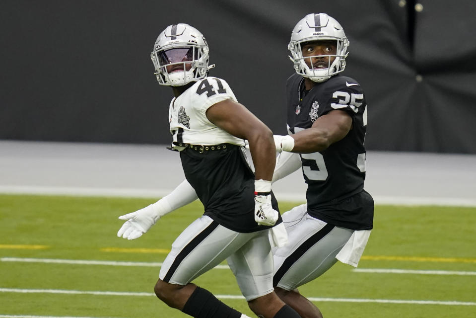 Las Vegas Raiders cornerback Amik Robertson (41) guards running back Theo Riddick (35) during an NFL football training camp practice Friday, Aug. 28, 2020, in Las Vegas. (AP Photo/John Locher)