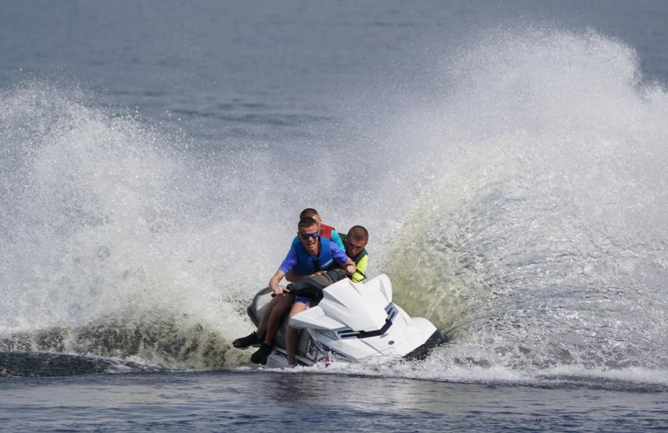 People on jet skis in the water of Loch Lomond (PA) (PA Wire)