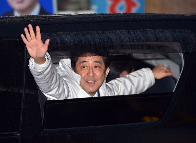 Japan's main opposition Liberal Democratic Party (LDP) leader Shinzo Abe waves to supporters after speaking in support of his party's candidate in Matsudo city, suburban Tokyo on December 15, 2012. Voters began casting ballots in Japan on Sunday for a general election likely to return long-ruling conservatives to power after three years in the wilderness