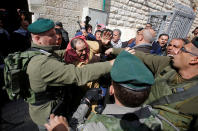 <p>A Palestinian man scuffles with Israeli border policemen during a protest calling for the reopening of a closed street in the West Bank city of Hebron on Feb. 17, 2017. (Photo: Mussa Qawasma/Reuters) </p>