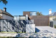 <p><strong>The Style Guide:</strong> There's no shame in a classic concrete driveway. In fact, concrete can be the perfect fit for a modern home, like this one designed by <a href="https://www.robsonrak.com.au/" rel="nofollow noopener" target="_blank" data-ylk="slk:Robson Rak;elm:context_link;itc:0;sec:content-canvas" class="link ">Robson Rak</a>. If you have an automatic garage door, which most modern homes do, opt for this clean, sleek exterior. It completely complements the style of the home, blending in nicely rather than dominating the view.</p><p><strong>The Practical Need-to-Know:</strong> You can use concrete pavers or pour concrete, which will be different in both form and function. Pavers won't require a curing period, they have more traction, and it has super high psi, meaning it can withstand a ton of pressure (that's one of the reasons it's so common). The key to keeping it from looking dirty is maintenance and diligence (although tree roots and other natural causes can create cracks). </p>