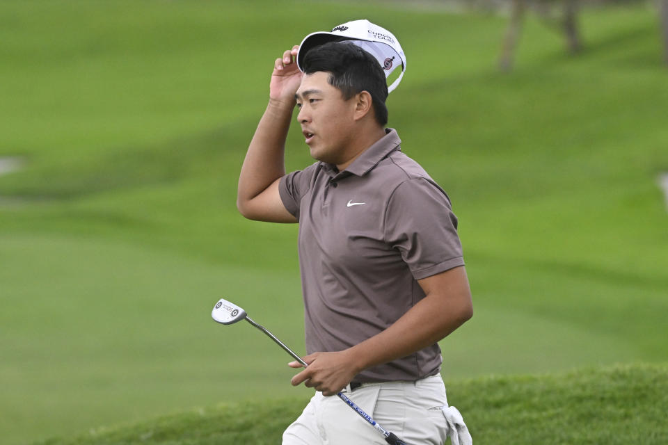 Kevin Yu tips his cap after finishing the first round on the North Course at Torrey Pines during the Farmers Insurance Open golf tournament Wednesday, Jan. 24, 2024, in San Diego. (AP Photo/Denis Poroy)