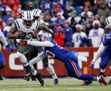 Jan 3, 2016; Orchard Park, NY, USA; New York Jets running back Chris Ivory (33) breaks a tackle by Buffalo Bills strong safety Bacarri Rambo (30) during the second half at Ralph Wilson Stadium. Mandatory Credit: Kevin Hoffman-USA TODAY Sports
