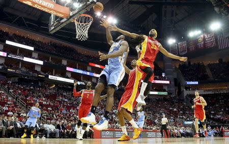 Mar 19, 2015; Houston, TX, USA; Denver Nuggets forward Kenneth Faried (35) shoots against Houston Rockets guard Corey Brewer (33) in the second half at Toyota Center. Rockets won 118 to 108. Mandatory Credit: Thomas B. Shea-USA TODAY Sports