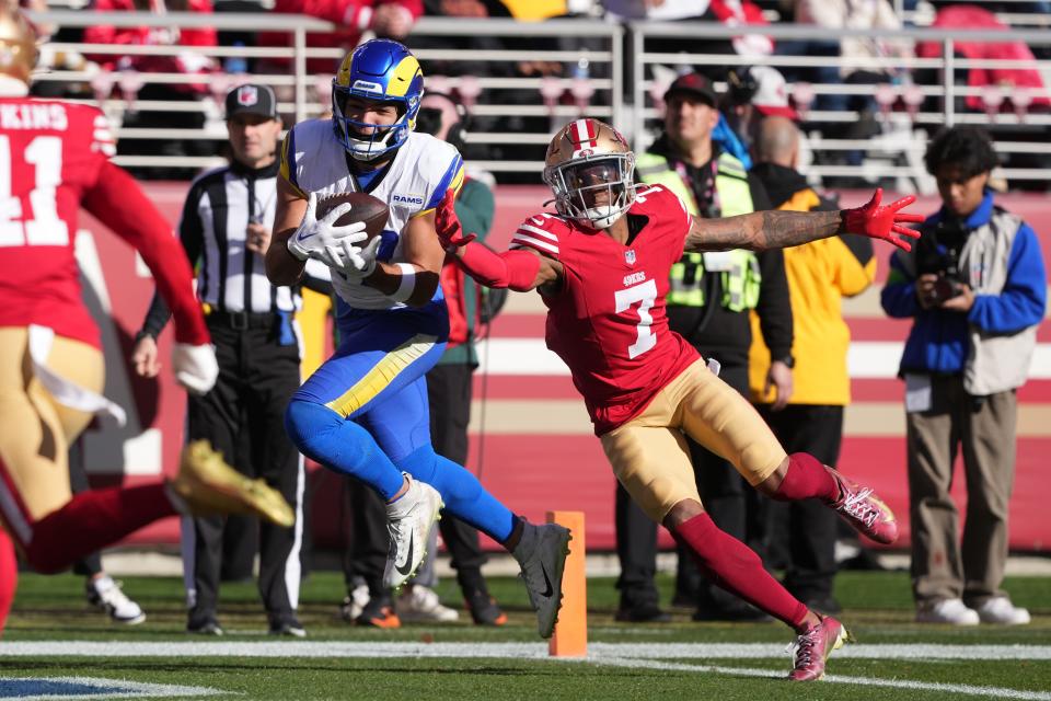 Rams wide receiver Puka Nacua catches a 19-yard touchdown pass during the first quarter of Sunday's game against the 49ers. The catch helped Nacua tie the all-time rookie record for receiving yards in a season.
